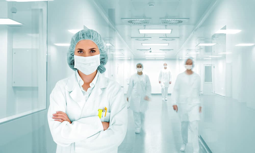 A hospital employee in a sterile hallway